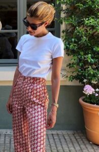 White tee with high-waisted trousers with a white-and-red flower print