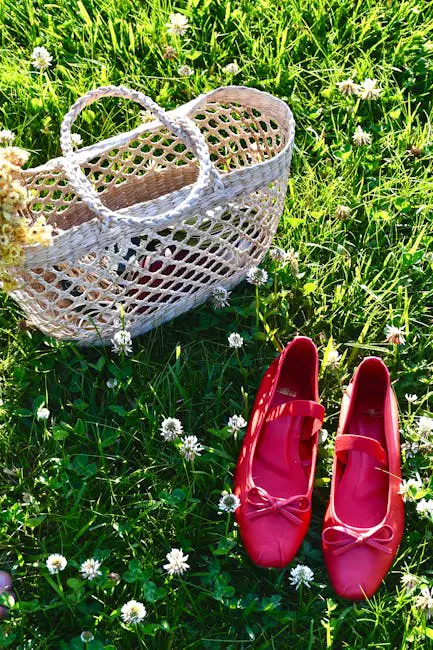 Pink ballet flats and a woven bag on a green lawn with flowers. Perfect summer vibe.