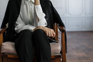 A professional woman sitting in an office armchair, highlighting a calm and thoughtful mood.